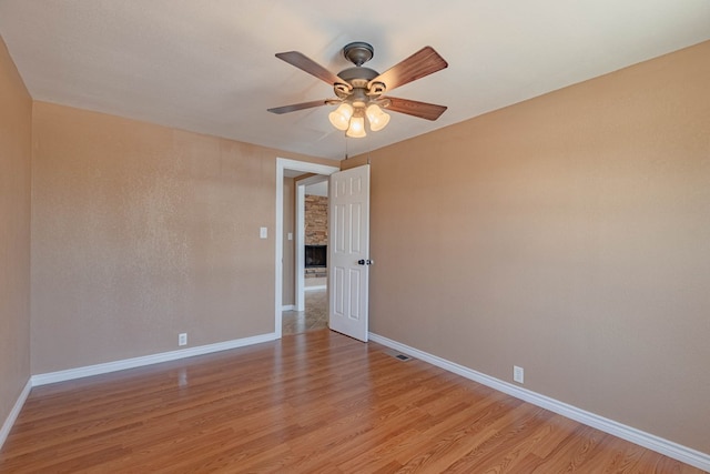 empty room featuring ceiling fan and light hardwood / wood-style flooring