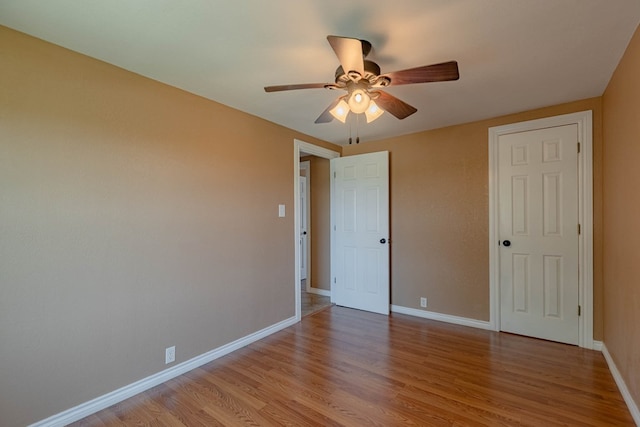 unfurnished bedroom with ceiling fan and light wood-type flooring