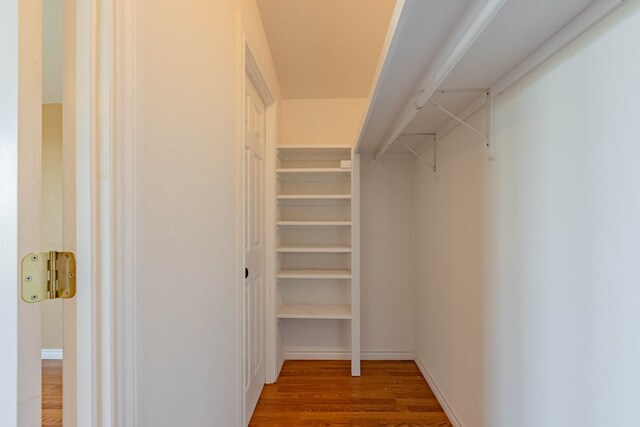 walk in closet with hardwood / wood-style floors