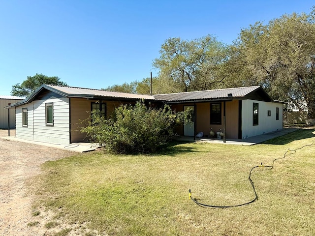 rear view of house featuring a yard and a patio area