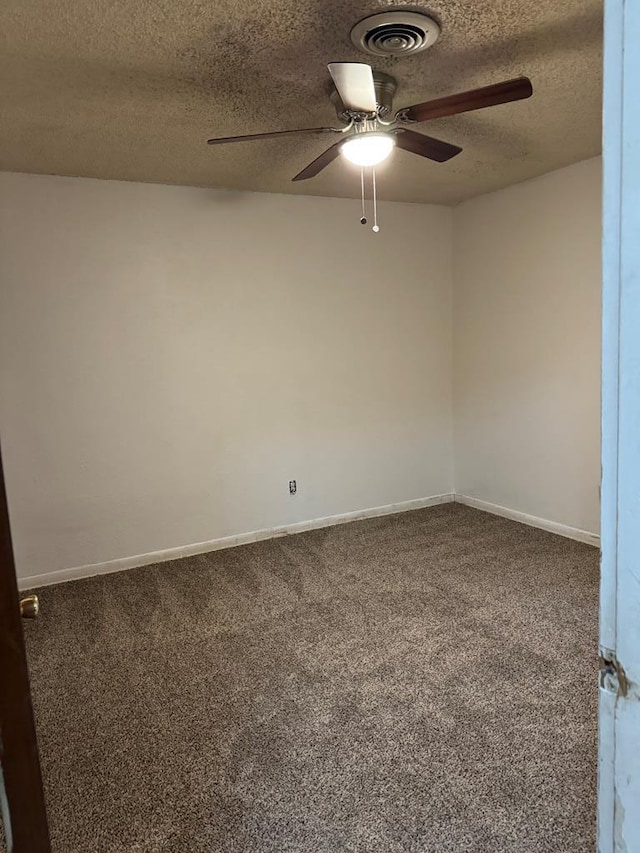 carpeted empty room featuring baseboards, visible vents, ceiling fan, and a textured ceiling