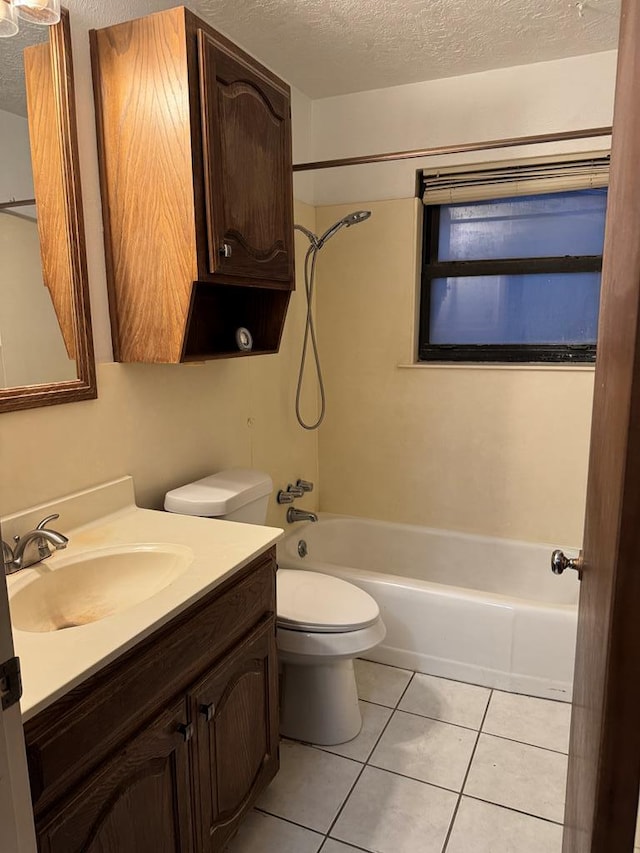 full bathroom with a textured ceiling, toilet, shower / bath combination, vanity, and tile patterned floors