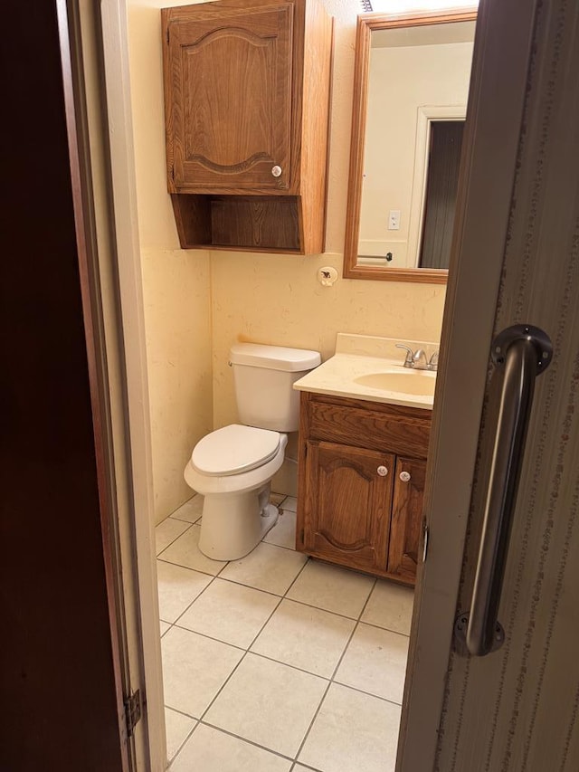 bathroom with vanity, toilet, and tile patterned floors