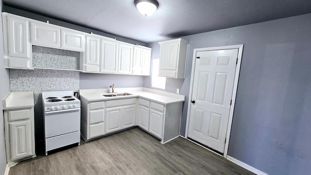 kitchen with sink, white range, wood-type flooring, decorative backsplash, and white cabinets