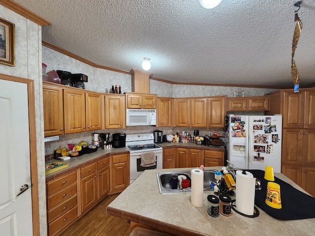 kitchen with vaulted ceiling, light wood-type flooring, white appliances, and ornamental molding