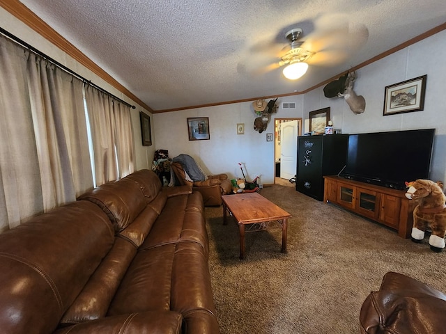 living room featuring ceiling fan, carpet, a textured ceiling, and ornamental molding