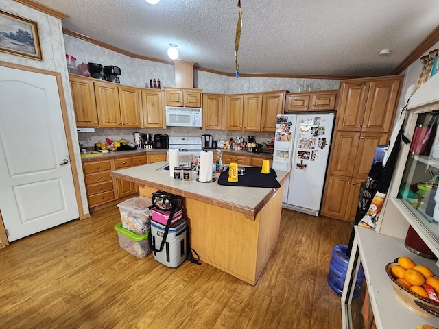 kitchen featuring a center island, lofted ceiling, white appliances, light hardwood / wood-style flooring, and a textured ceiling