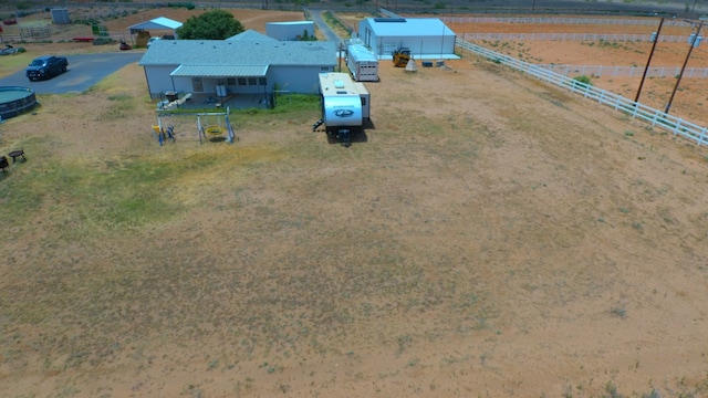 birds eye view of property with a rural view