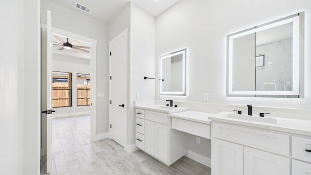 full bath featuring double vanity, wood finish floors, a sink, and visible vents