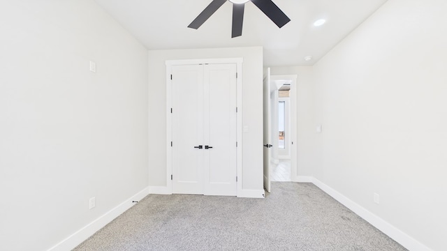 unfurnished bedroom with carpet, recessed lighting, a closet, ceiling fan, and baseboards