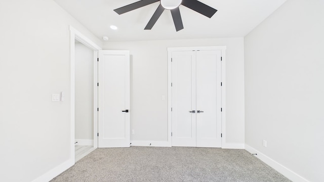 unfurnished bedroom featuring recessed lighting, a closet, a ceiling fan, carpet flooring, and baseboards