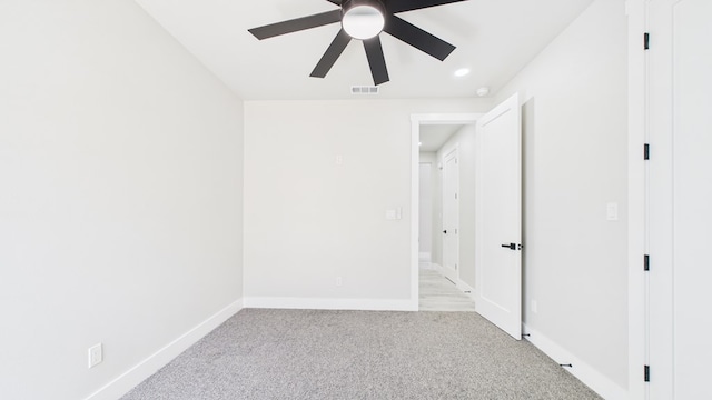 unfurnished bedroom featuring a ceiling fan, visible vents, light carpet, and baseboards