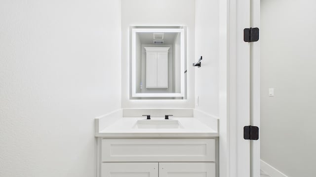 bathroom featuring vanity and baseboards