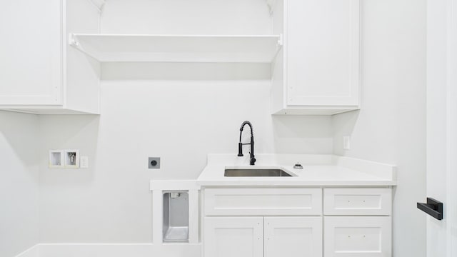 washroom with electric dryer hookup, a sink, cabinet space, and hookup for a washing machine