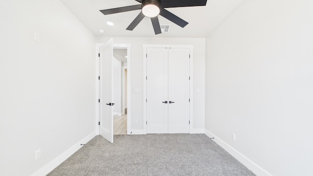 unfurnished bedroom with carpet floors, a closet, visible vents, ceiling fan, and baseboards