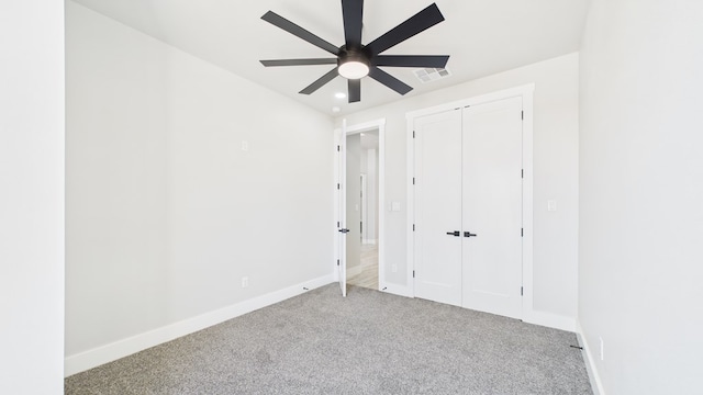 unfurnished bedroom featuring carpet, visible vents, ceiling fan, and baseboards