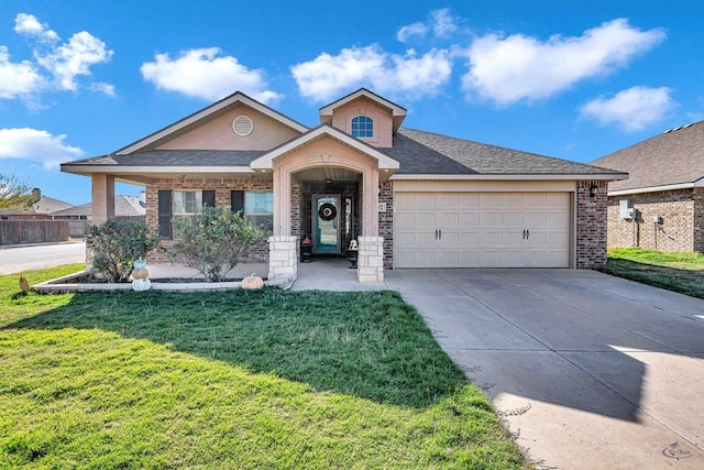 view of front of property with a garage and a front yard