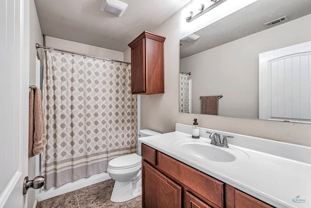 bathroom featuring tile patterned floors, vanity, a textured ceiling, and toilet