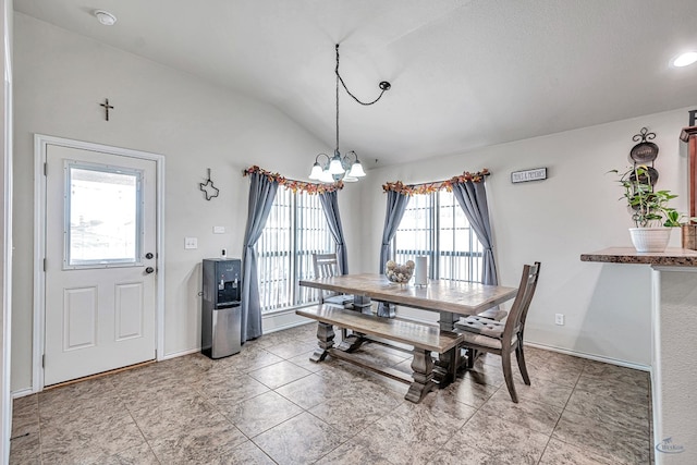 tiled dining area featuring a chandelier, plenty of natural light, and lofted ceiling