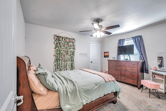 bedroom with carpet, ceiling fan, and a textured ceiling