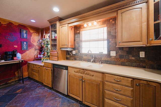 kitchen featuring dishwasher, glass insert cabinets, light countertops, and a sink