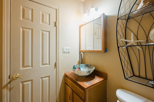 bathroom featuring toilet and vanity