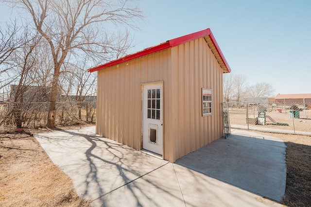 view of outdoor structure with an outbuilding and fence