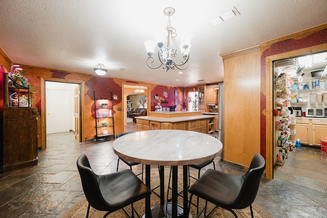 dining room with a textured ceiling, visible vents, a bar, stone tile flooring, and an inviting chandelier