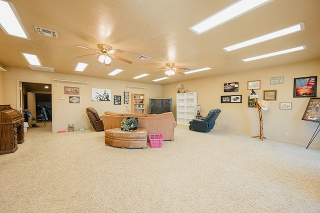 interior space featuring a ceiling fan, visible vents, and carpet flooring