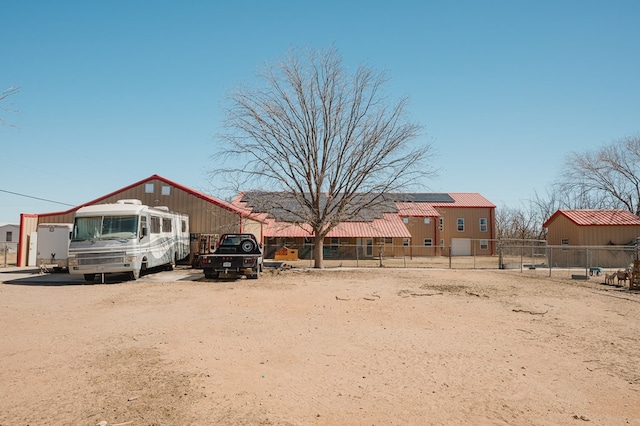 view of front of home featuring fence