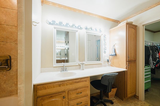 full bath featuring ornamental molding, a walk in closet, a bathtub, and vanity