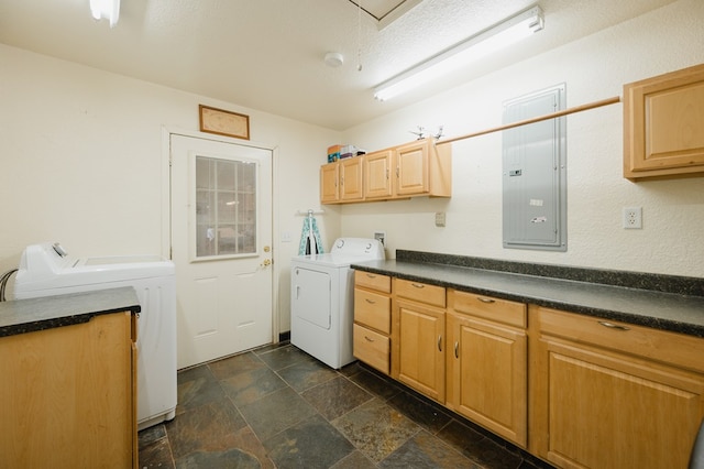 washroom featuring cabinet space, stone finish flooring, a textured ceiling, electric panel, and independent washer and dryer