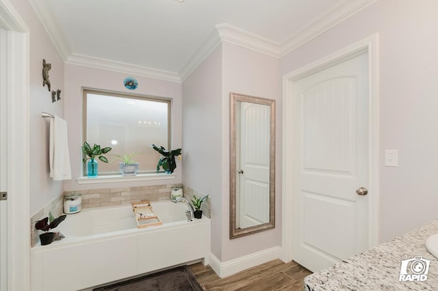 bathroom featuring ornamental molding, a washtub, and vanity