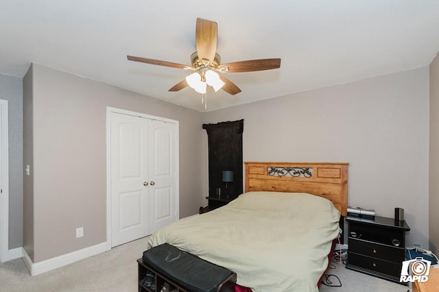 carpeted bedroom with ceiling fan and a closet