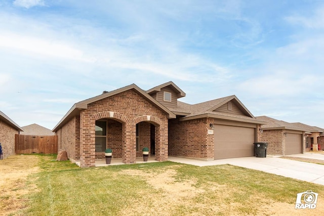 view of front of home with a garage and a front lawn