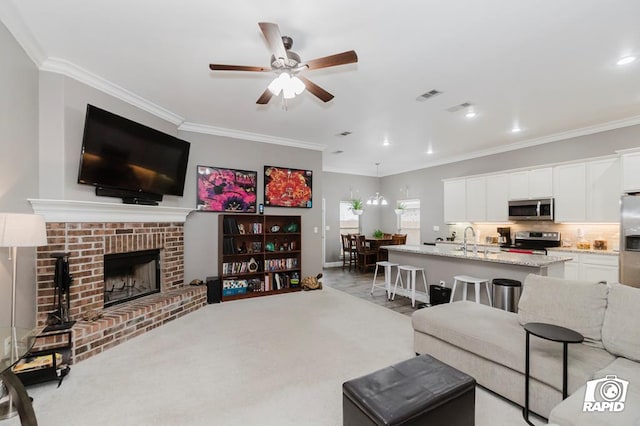 living room with light carpet, a brick fireplace, ornamental molding, and sink