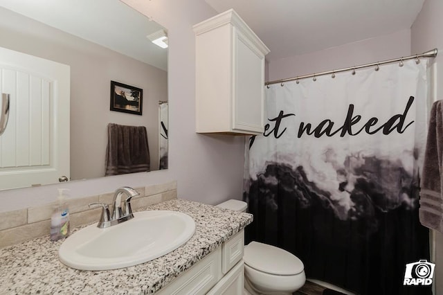 bathroom featuring vanity and toilet