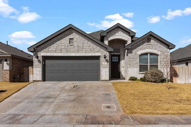 view of front of property with a front yard and a garage