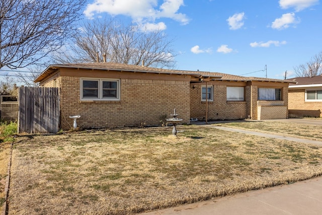 rear view of house featuring a lawn