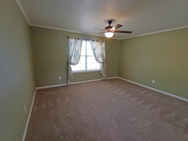 carpeted empty room featuring ceiling fan and crown molding