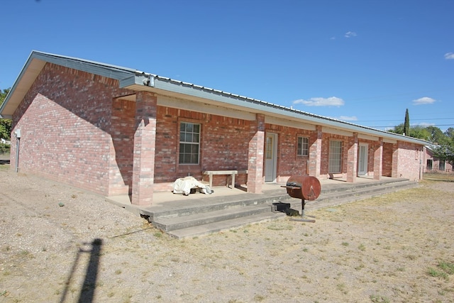 rear view of house featuring a porch