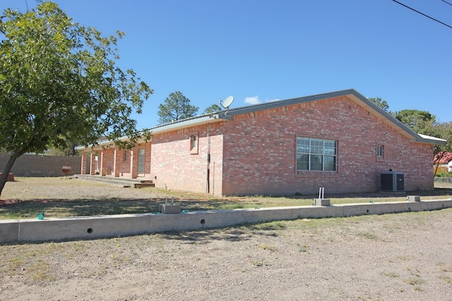 view of side of property featuring central AC unit