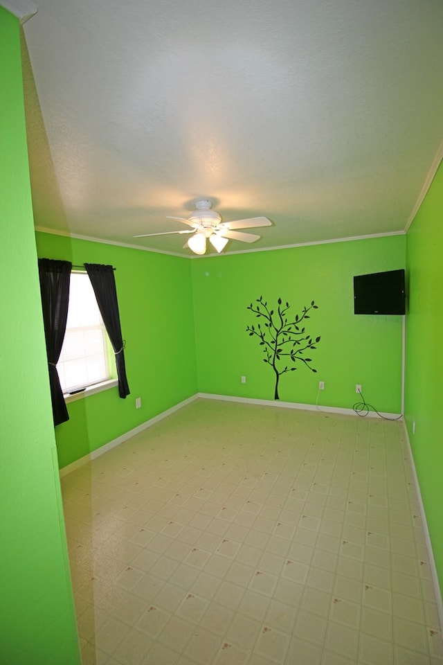 empty room with ceiling fan and crown molding