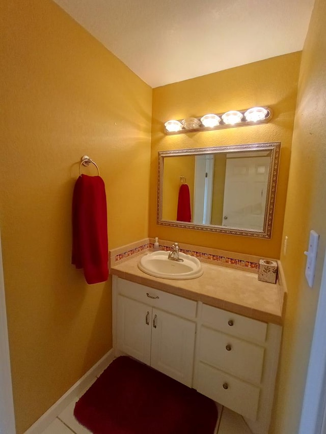 bathroom featuring tile patterned flooring and vanity