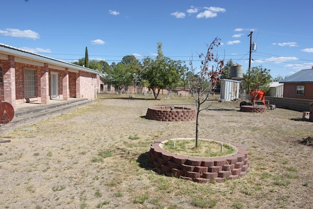 view of yard with an outdoor fire pit