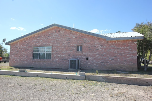 view of side of home with central AC