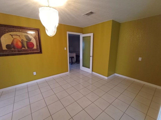 empty room featuring an inviting chandelier