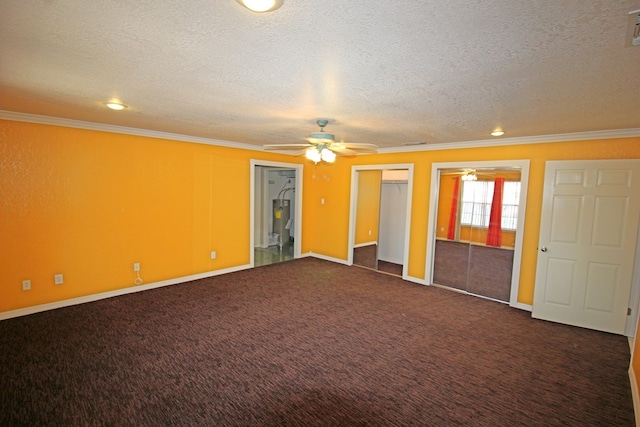 spare room featuring dark colored carpet, ceiling fan, crown molding, and a textured ceiling