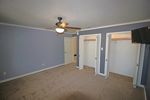 unfurnished bedroom with a textured ceiling, ceiling fan, carpet floors, and ornamental molding