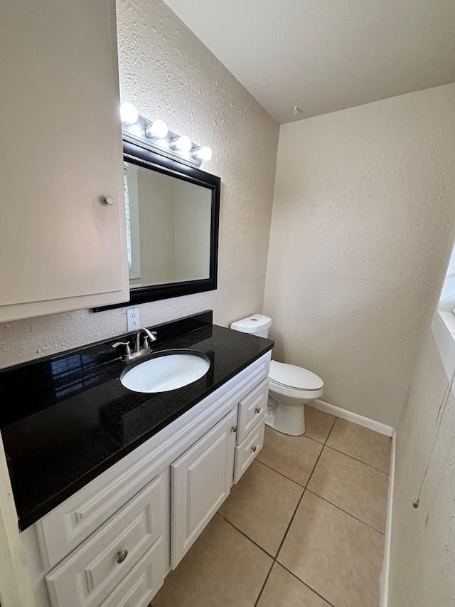 bathroom with tile patterned floors, vanity, and toilet